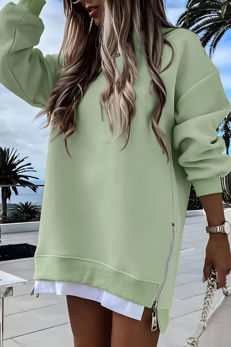 Women’s oversized jumper in green with side zip detail, styled for casual and smart-casual outfits.