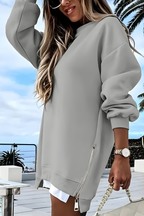 Women’s oversized jumper in grey with side zip detail, styled for casual and smart-casual outfits.
