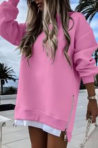 Women’s oversized jumper in pink with side zip detail, styled for casual and smart-casual outfits.