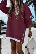 Women’s oversized jumper in red with side zip detail, styled for casual and smart-casual outfits.