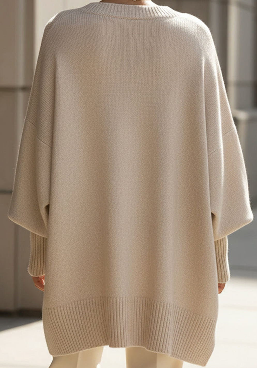 Women's knitted jumper in beige with an oversized fit, styled for casual and smart-casual outfits.