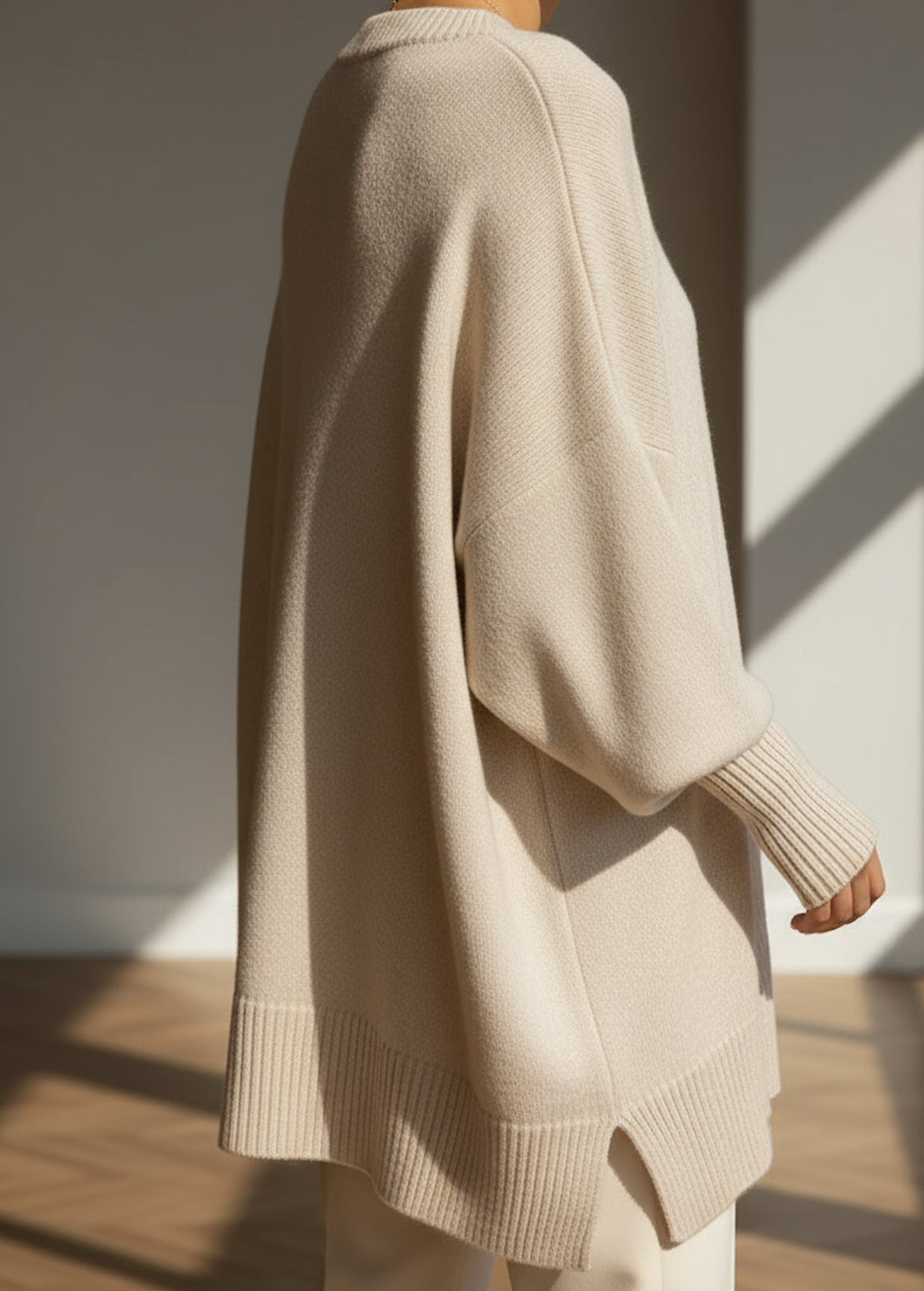 Women's knitted jumper in beige with an oversized fit, styled for casual and smart-casual outfits.