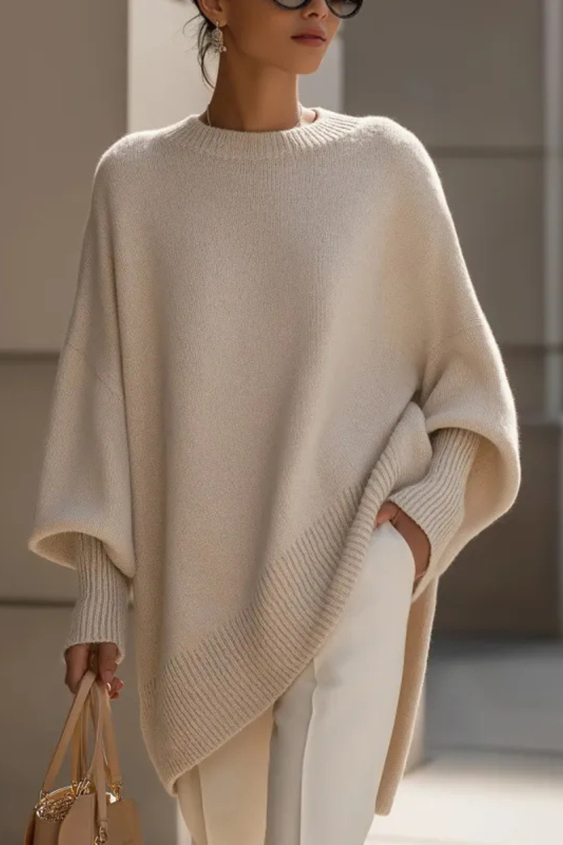 Women's knitted jumper in beige with an oversized fit, styled for casual and smart-casual outfits.