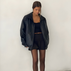 Women's oversized leather jacket in brown with dropped shoulders, styled for casual and smart-casual outfits.