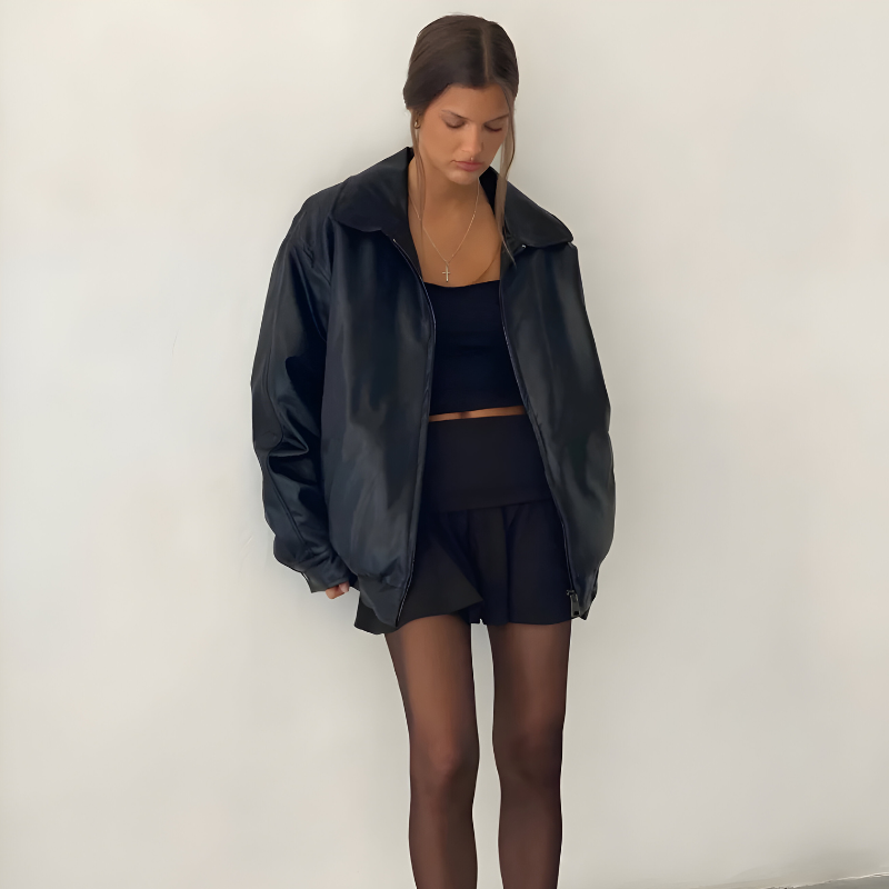 Women's oversized leather jacket in brown with dropped shoulders, styled for casual and smart-casual outfits.