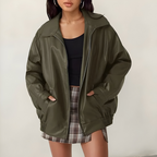 Women's oversized leather jacket in green with dropped shoulders, styled for casual and smart-casual outfits.