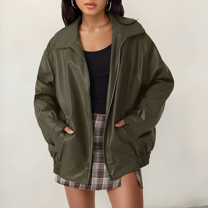 Women's oversized leather jacket in green with dropped shoulders, styled for casual and smart-casual outfits.