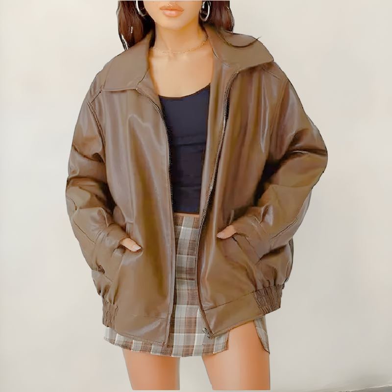 Women's oversized leather jacket in light brown with dropped shoulders, styled for casual and smart-casual outfits.