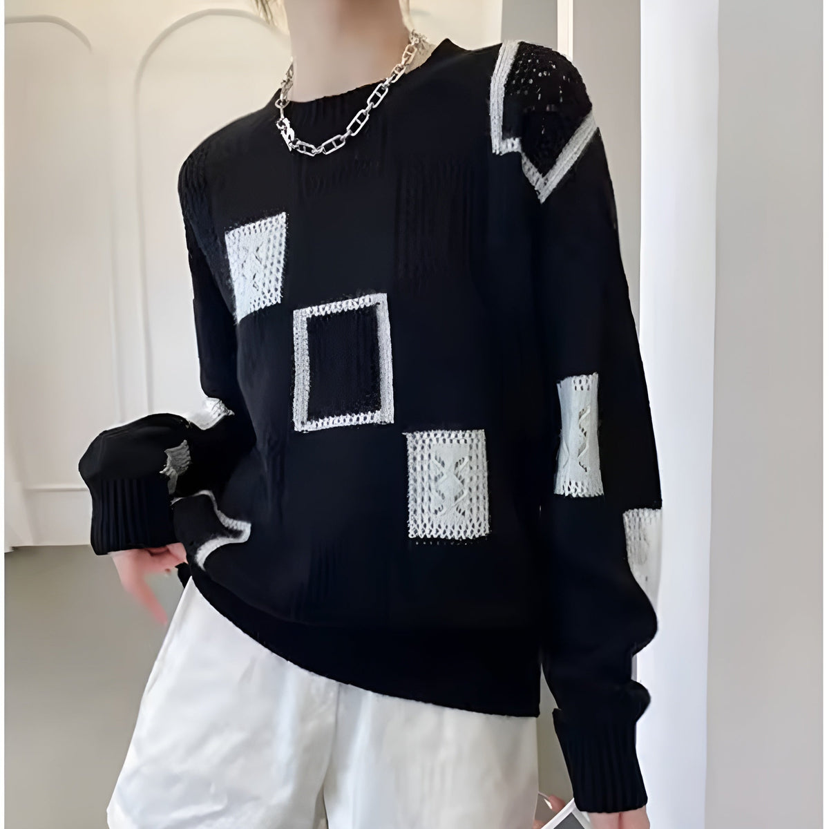 Women's patchwork jumper in white with panelled design, styled for casual and smart-casual outfits.
