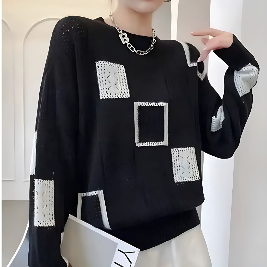 Women's patchwork jumper in black with panelled design, styled for casual and smart-casual outfits.