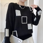Women's patchwork jumper in black with panelled design, styled for casual and smart-casual outfits.