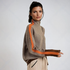 Women's roll-neck jumper in orange with all-over print, styled for casual and smart-casual outfits.