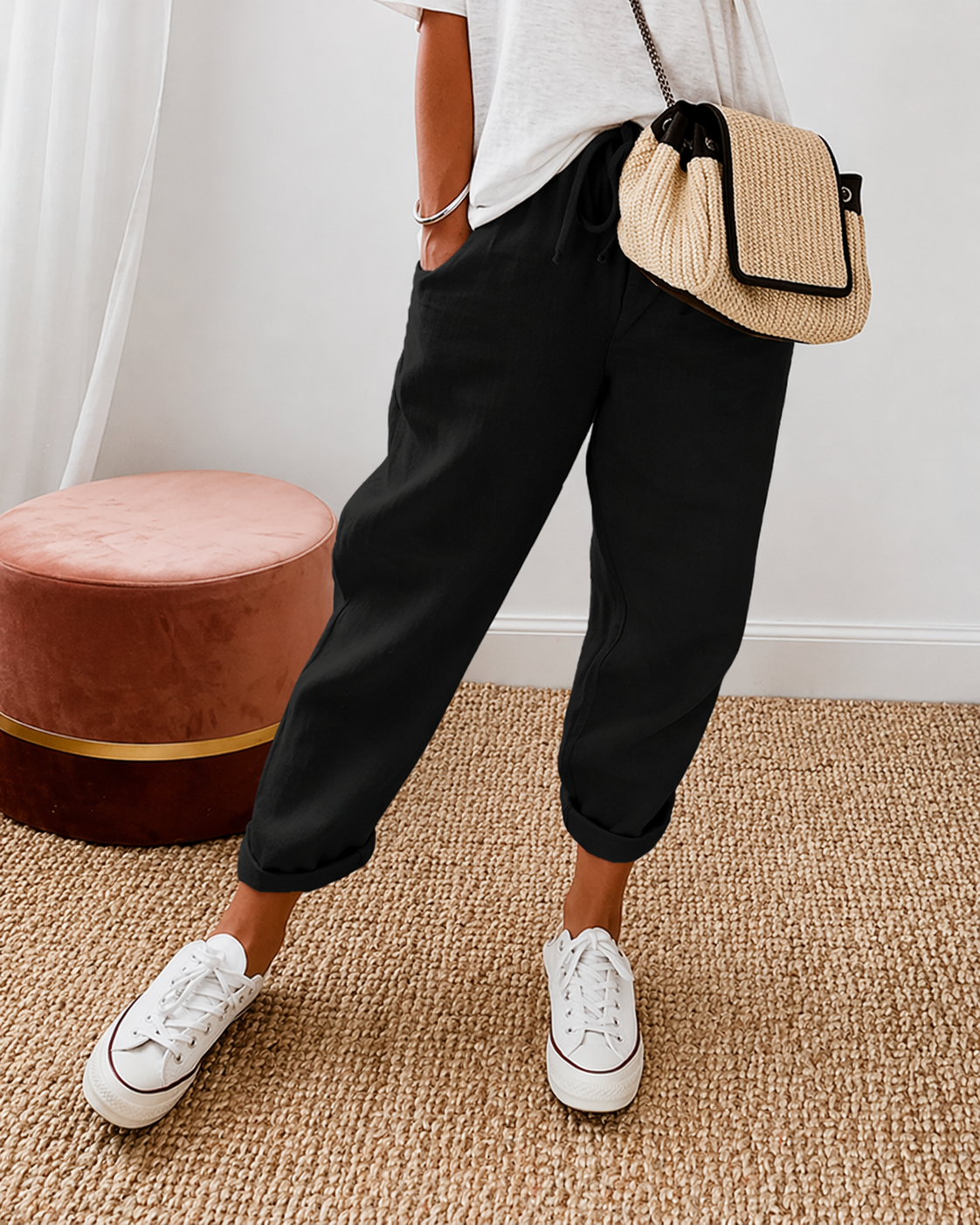 Women's relaxed fit trousers in black with elasticated waist, styled for casual and smart-casual outfits.