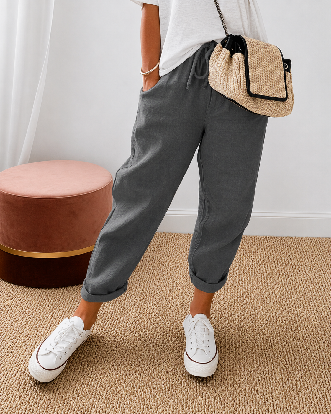Women's relaxed fit trousers in dark grey with elasticated waist, styled for casual and smart-casual outfits.