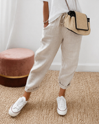 Women's relaxed fit trousers in khaki with elasticated waist, styled for casual and smart-casual outfits.