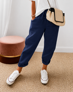Women's relaxed fit trousers in navy with elasticated waist, styled for casual and smart-casual outfits.