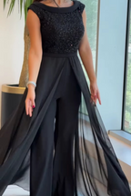 Women's sleeveless jumpsuit in black with a structured fit, styled for casual and smart-casual outfits.