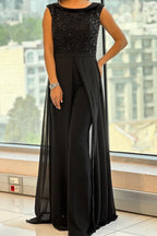 Women's sleeveless jumpsuit in black with a structured fit, styled for casual and smart-casual outfits.