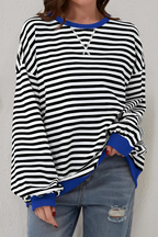 Women's sweatshirt in black with striped pattern, styled for casual and smart-casual outfits.