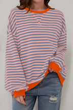 Women's sweatshirt in pink with striped pattern, styled for casual and smart-casual outfits.