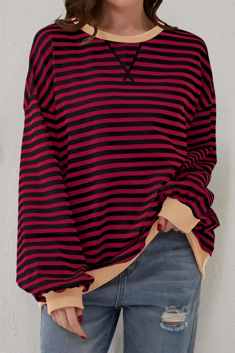Women's sweatshirt in red with striped pattern, styled for casual and smart-casual outfits.