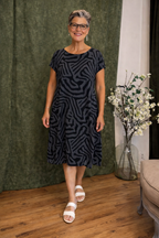 Women's midi dress in black with a relaxed cut, styled for casual and smart-casual outfits.