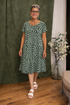Women's midi dress in green with a relaxed cut, styled for casual and smart-casual outfits.