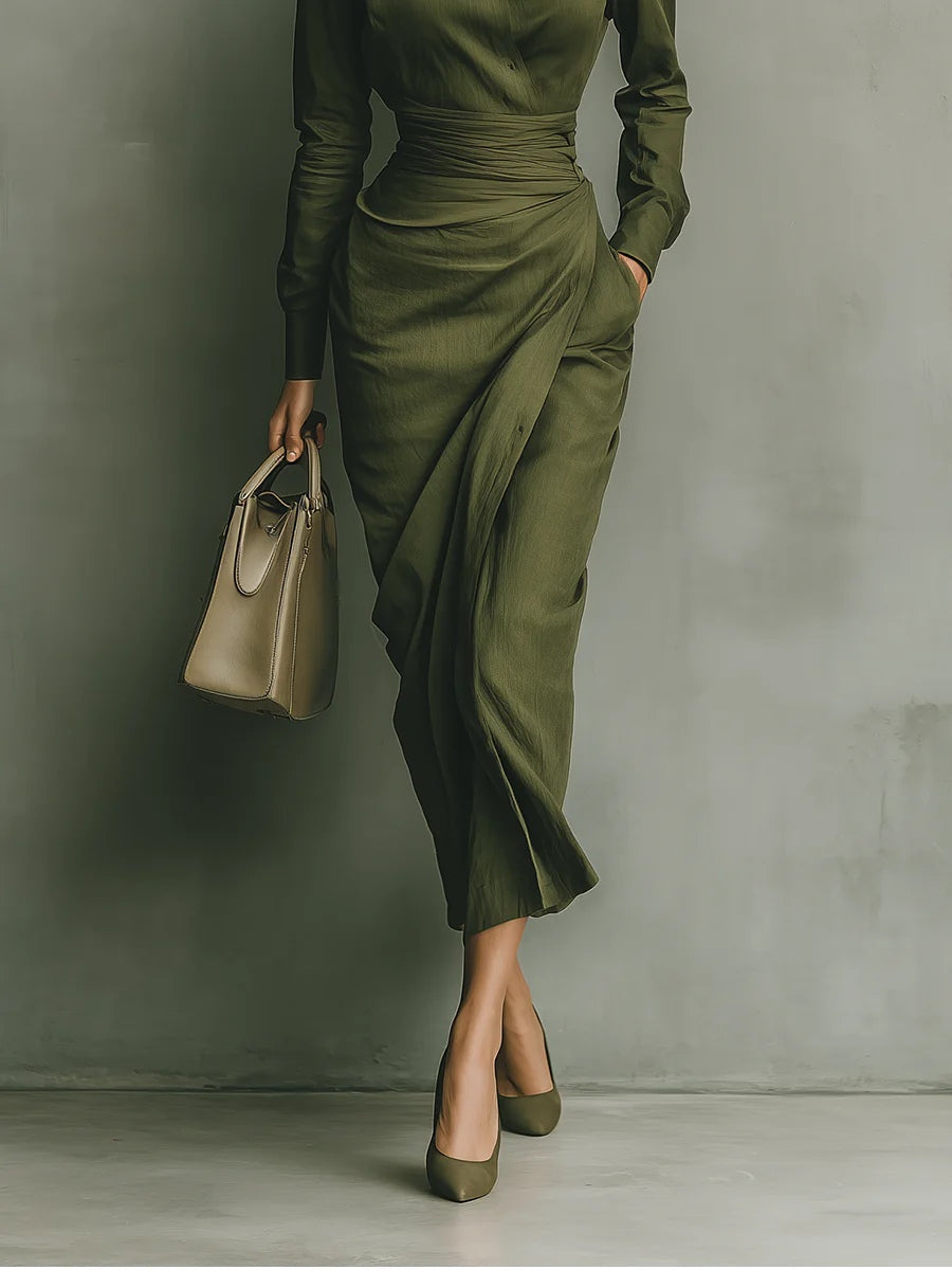 Women's wrap dress in green with a tailored waist, styled for casual and smart-casual outfits.