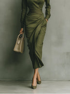 Women's wrap dress in green with a tailored waist, styled for casual and smart-casual outfits.