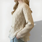 Women's jumper in beige with textured ruffle detailing, styled for casual and smart-casual outfits.