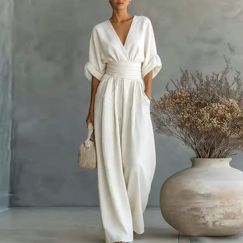 Women's jumpsuit in white with deep V-neck, styled for casual and smart-casual outfits.