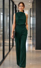 Women's sleeveless jumpsuit in dark green with wide legs, styled for casual and smart-casual outfits.
