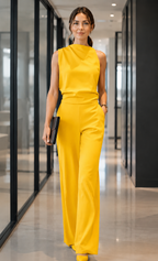 Women's sleeveless jumpsuit in yellow with wide legs, styled for casual and smart-casual outfits.